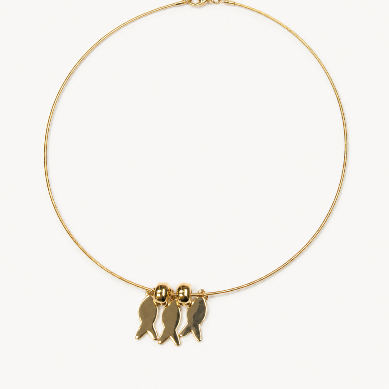 Pendant-focused flexible gold-tone choker with three fish charms — SKU IZZ279