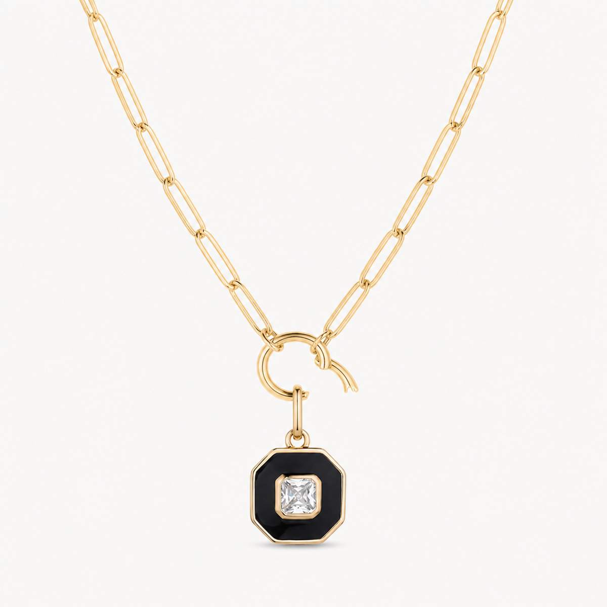 black enamel & cubic zirconia octagon charm shown on a gold paperclip charm necklace
