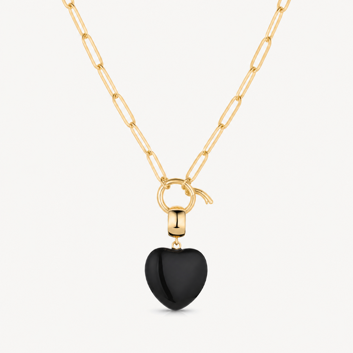 black onyx small smooth heart charm shown on a gold paperclip charm necklace