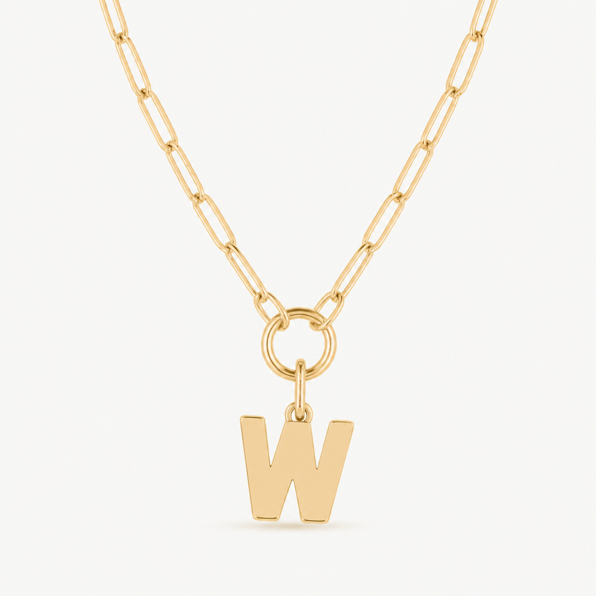 block initial charm shown on a gold paperclip charm necklace