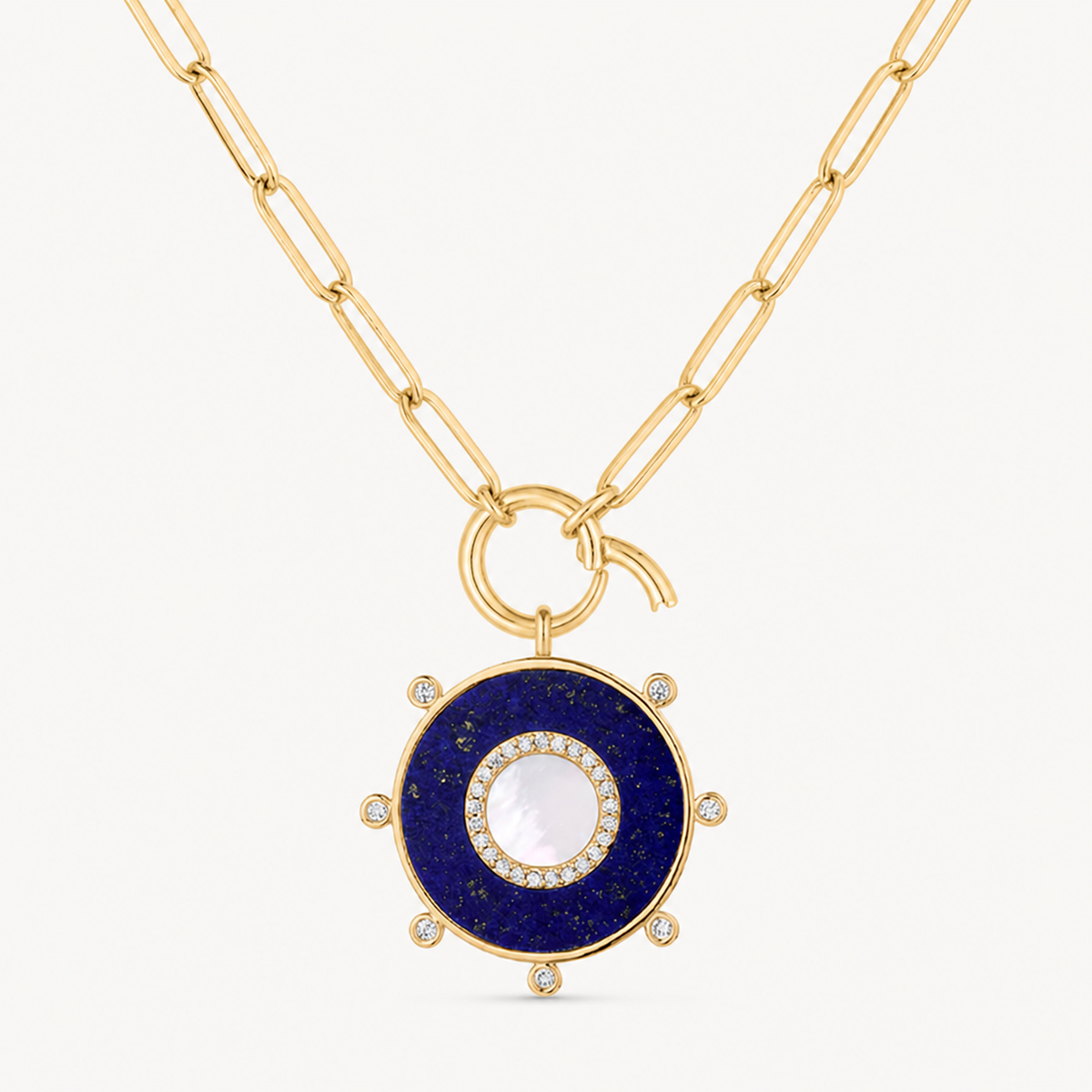 blue lapis & mother of pearl round charm shown on a gold paperclip charm necklace