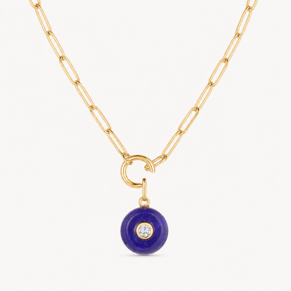 blue lapis smooth round charm shown on a gold paperclip charm necklace