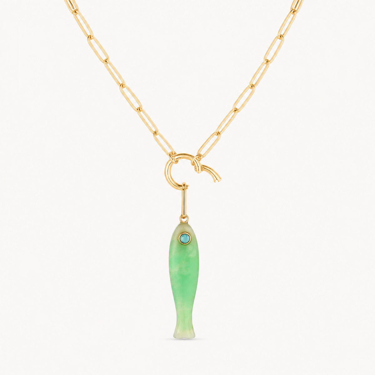 chrysoprase fish charm shown on a gold paperclip charm necklace