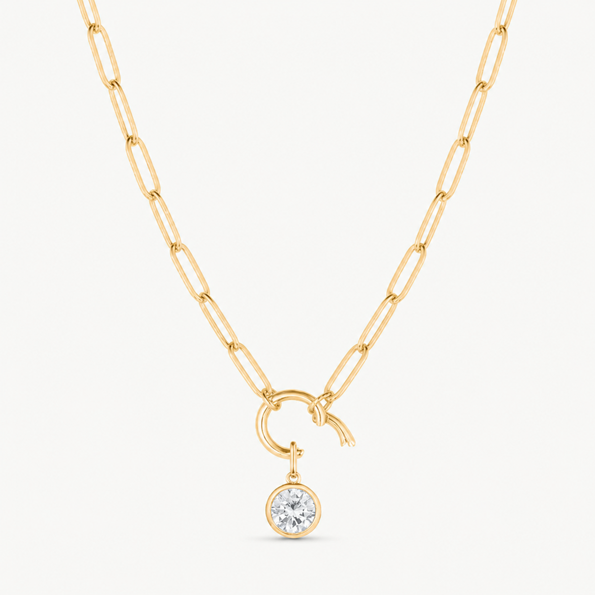 cubic zirconis round charm shown on a gold paperclip charm necklace