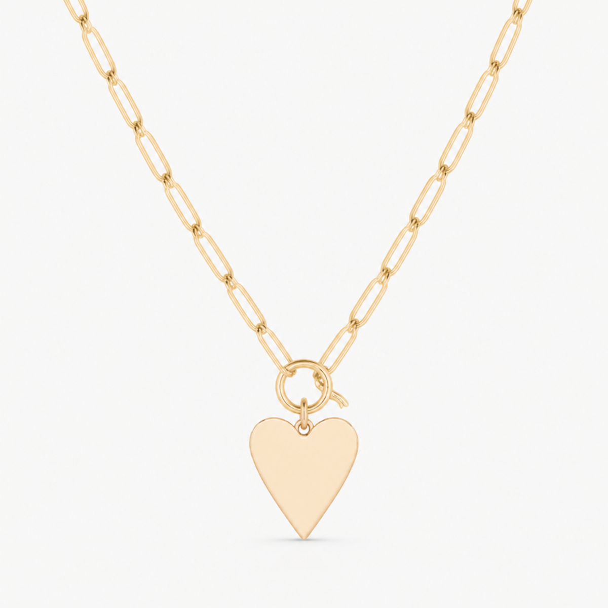 flat heart charm shown on a gold paperclip charm necklace