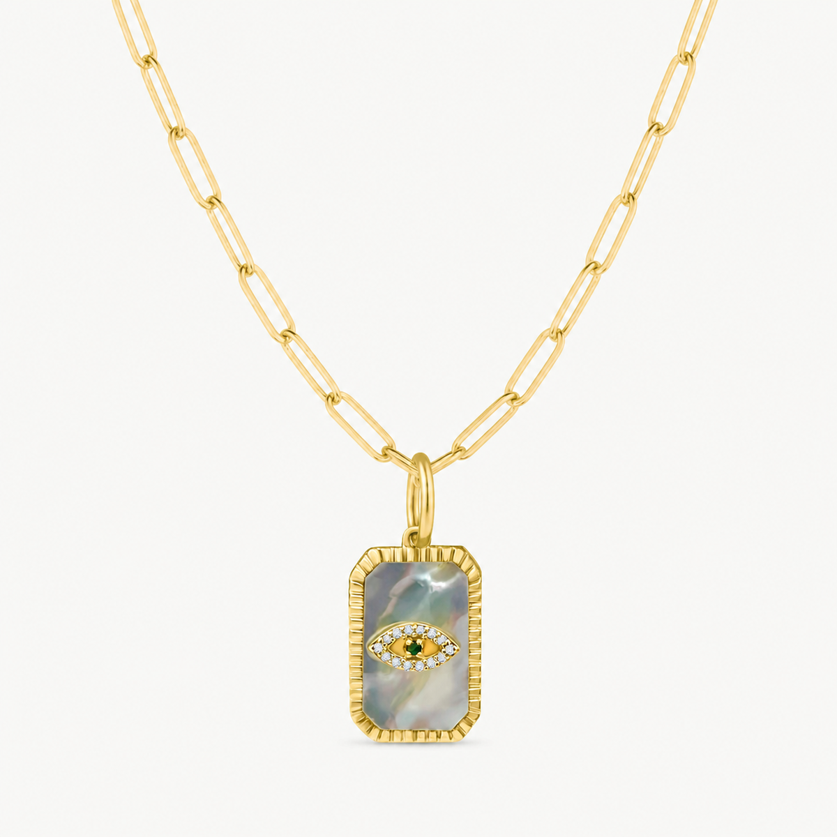 mother of pearl gold diamond and sapphire eye charm shown on a gold paperclip charm necklace