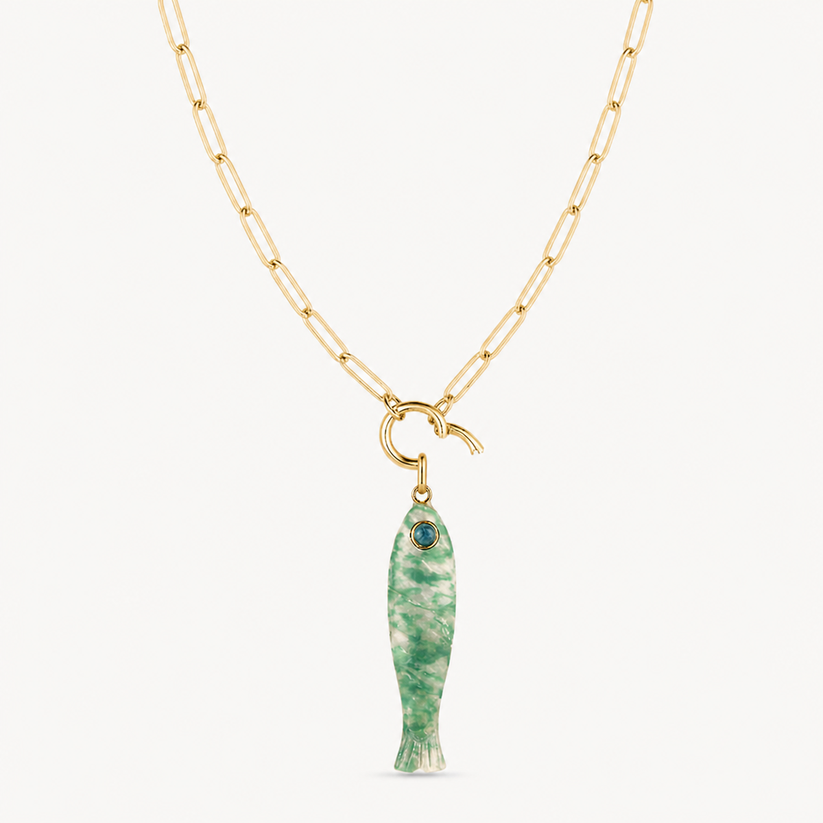 green dot fish charm shown on a gold paperclip charm necklace