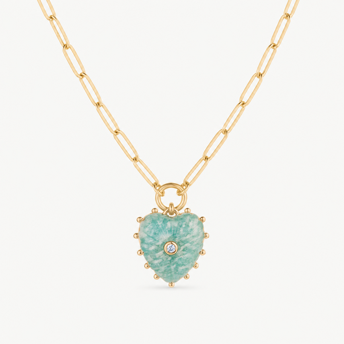 small amazonite carved heart charm shown on a gold paperclip charm necklace