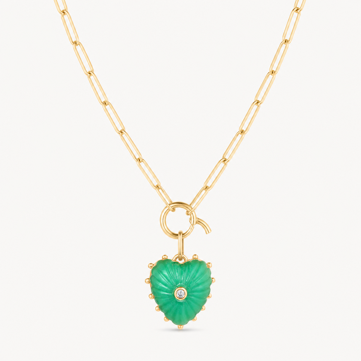 small chrysoprase carved heart charm shown on a gold paperclip charm necklace
