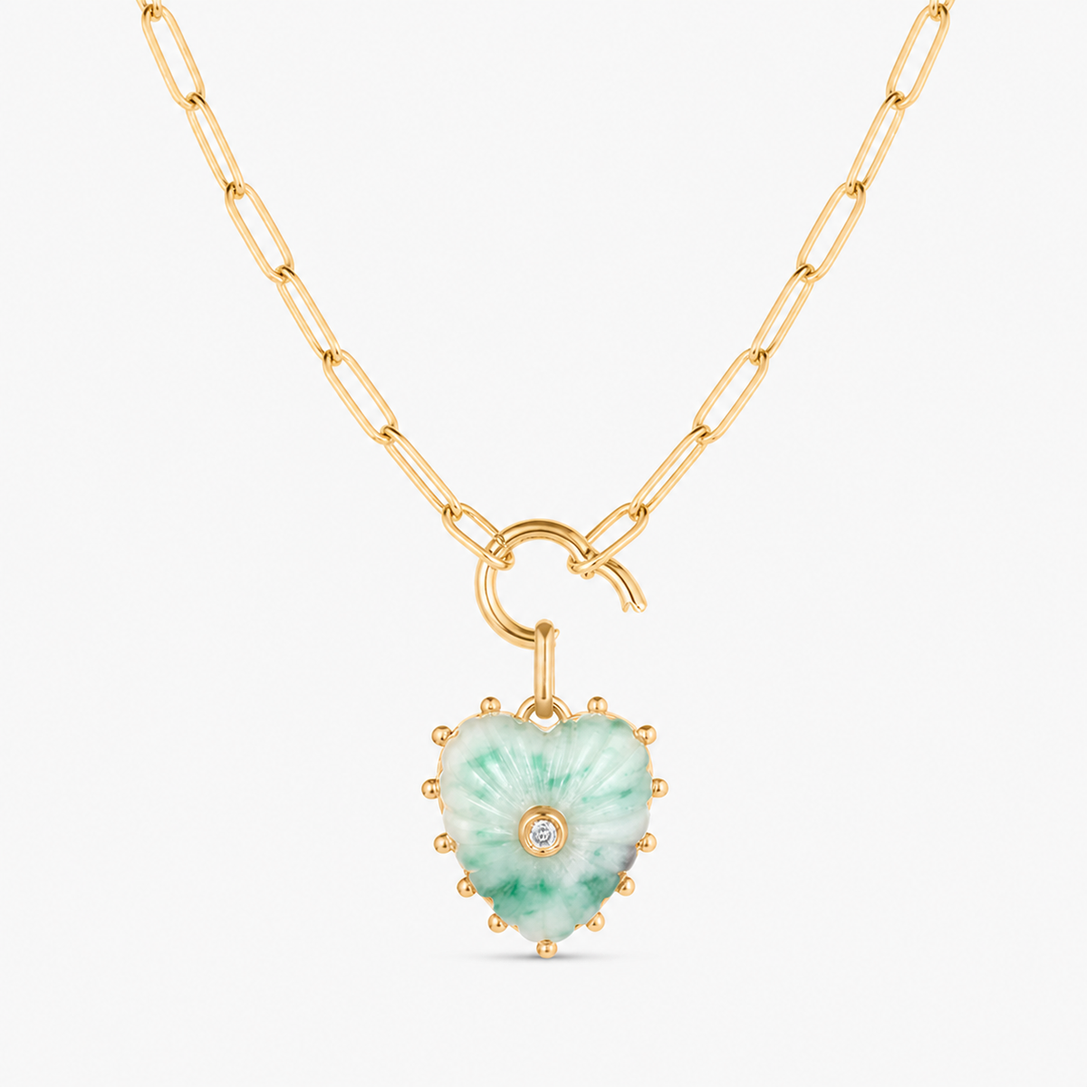 small green dot carved heart charm shown on a gold paperclip charm necklace