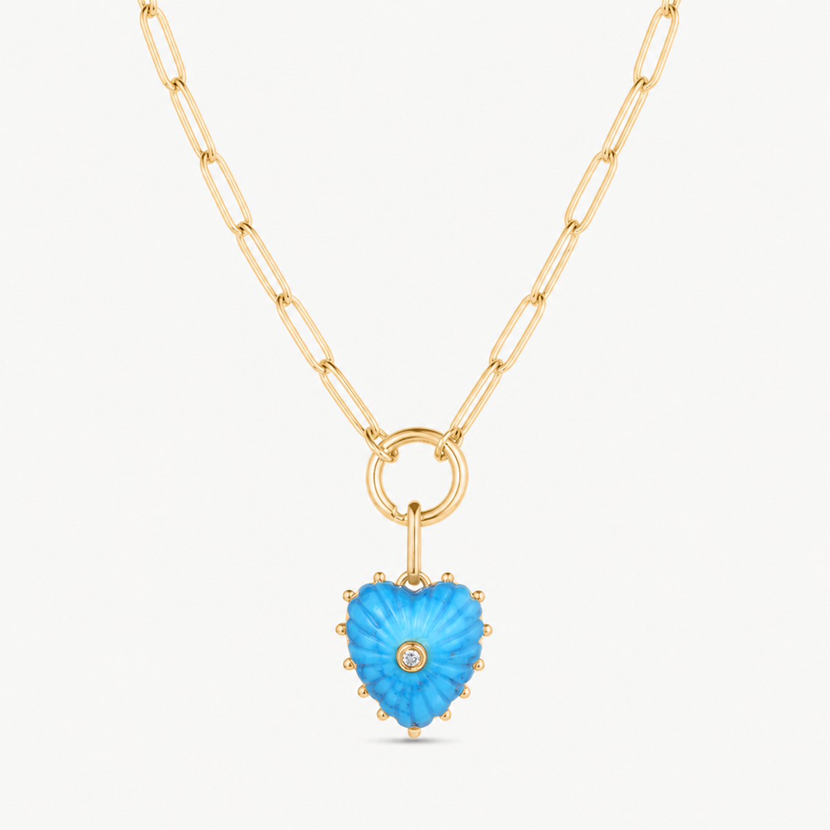 small howlite carved heart charm shown on a gold paperclip charm necklace