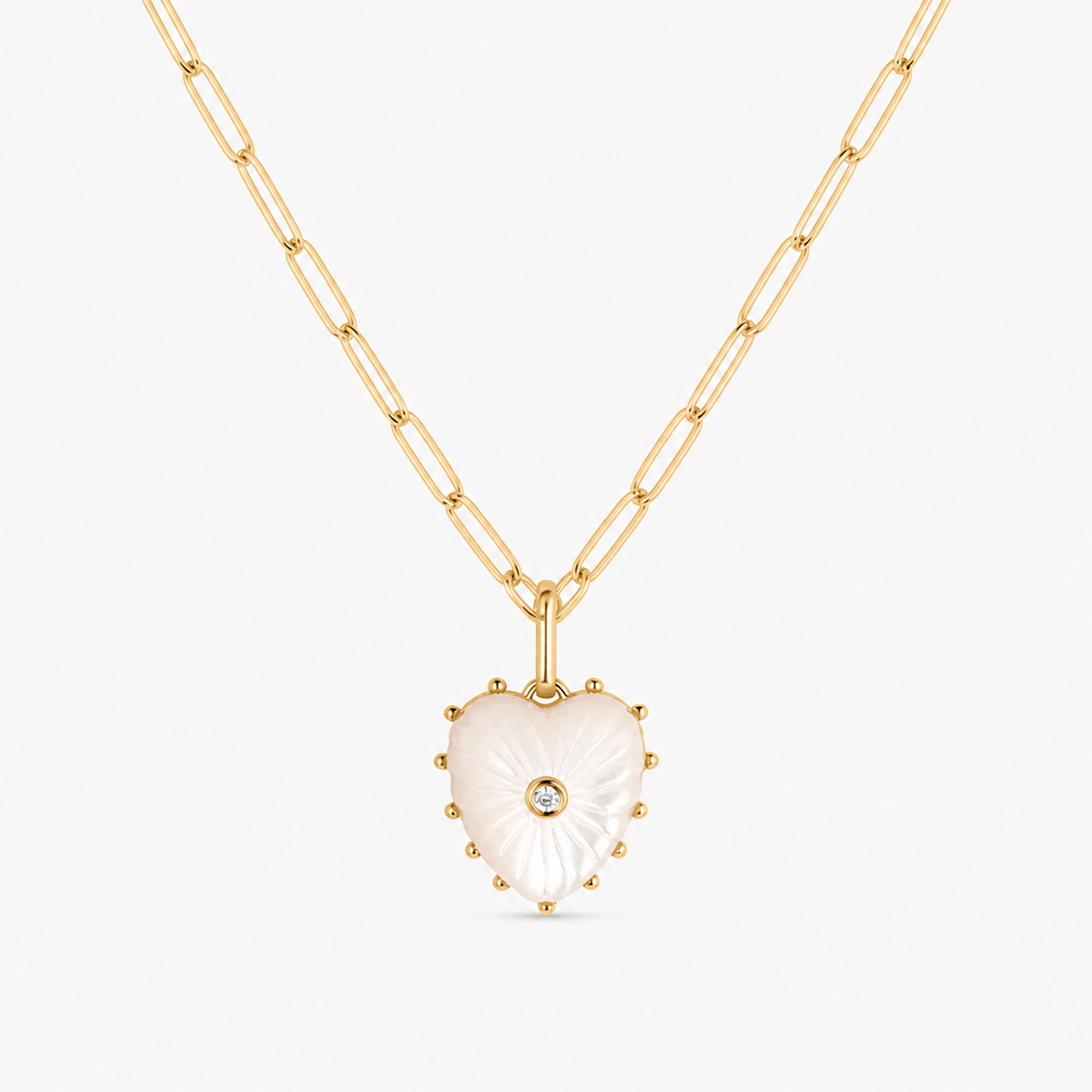 small mother of pearl carved heart charm shown on a gold paperclip charm necklace