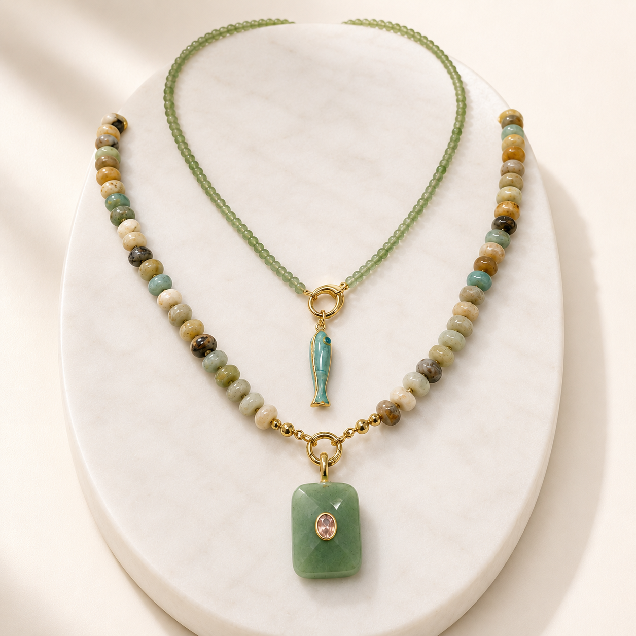 Two layered beaded necklaces with aventurine and fish pendants